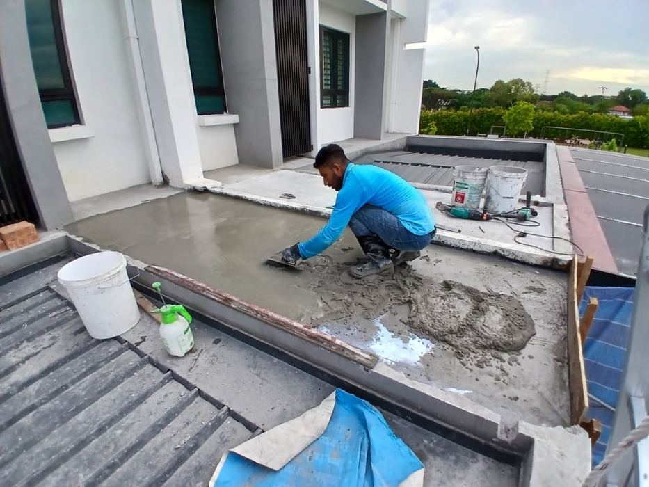 Victra technician coating a rooftop parapet with protective sealant