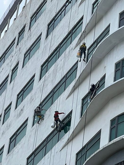 Victra worker applying waterproofing membrane on a balcony