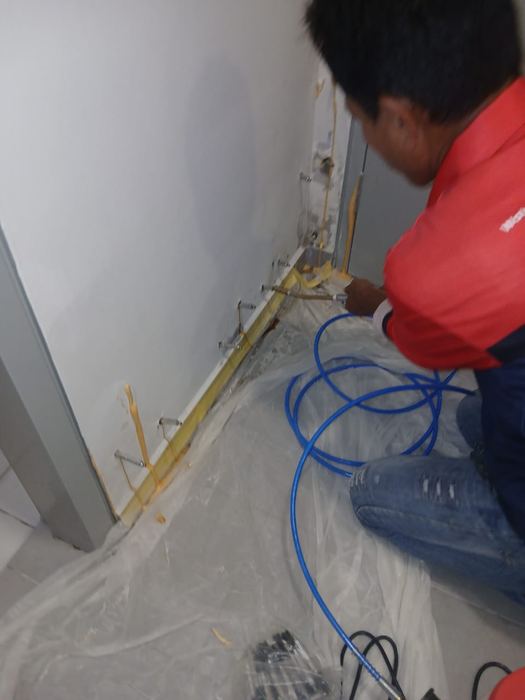Victra worker chasing a wall for concrete repair